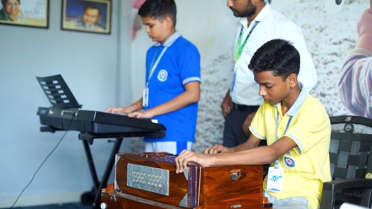 Students playing instruments in the music room